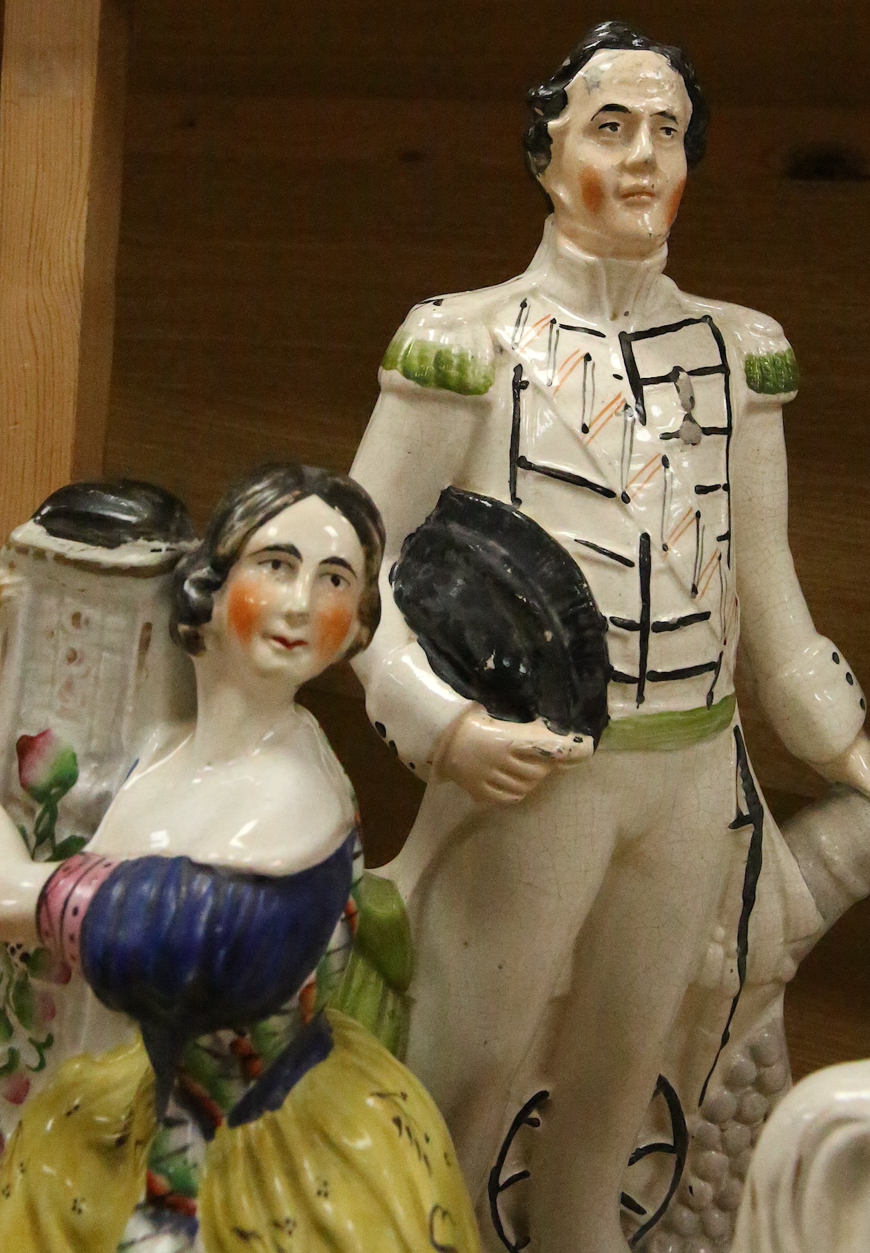 Staffordshire pottery: a bocage group, 25.5cm, 'Huntsman' 40.5cm, figure with child groom 40.5cm, figure of girl beside a column 30cm, George and Eliza Harris, 36cm, 'Dundas' beside a cannon, 40.5cm, gentleman and lady h